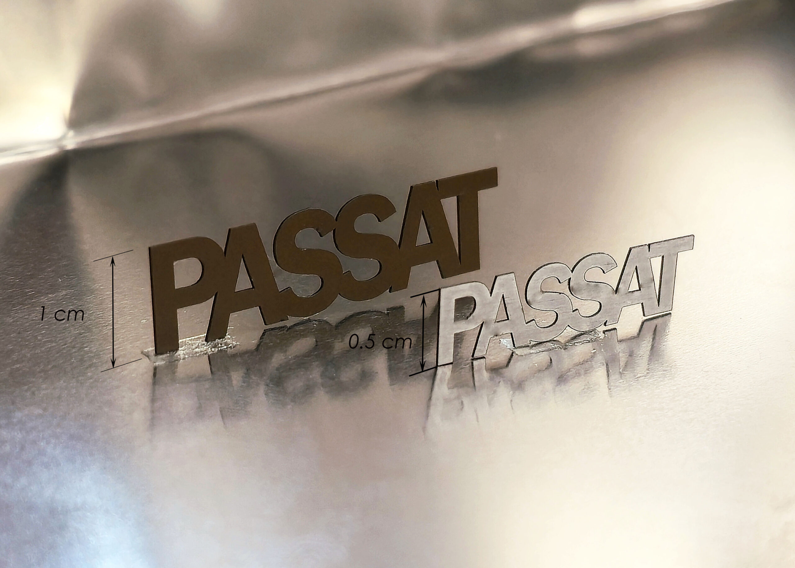 PASSAT letters laser-cut from a 250 micrometer thick aluminum sheet