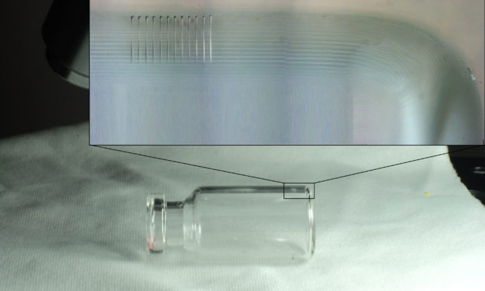 High-aspect ratio holes drilled in glass vial.