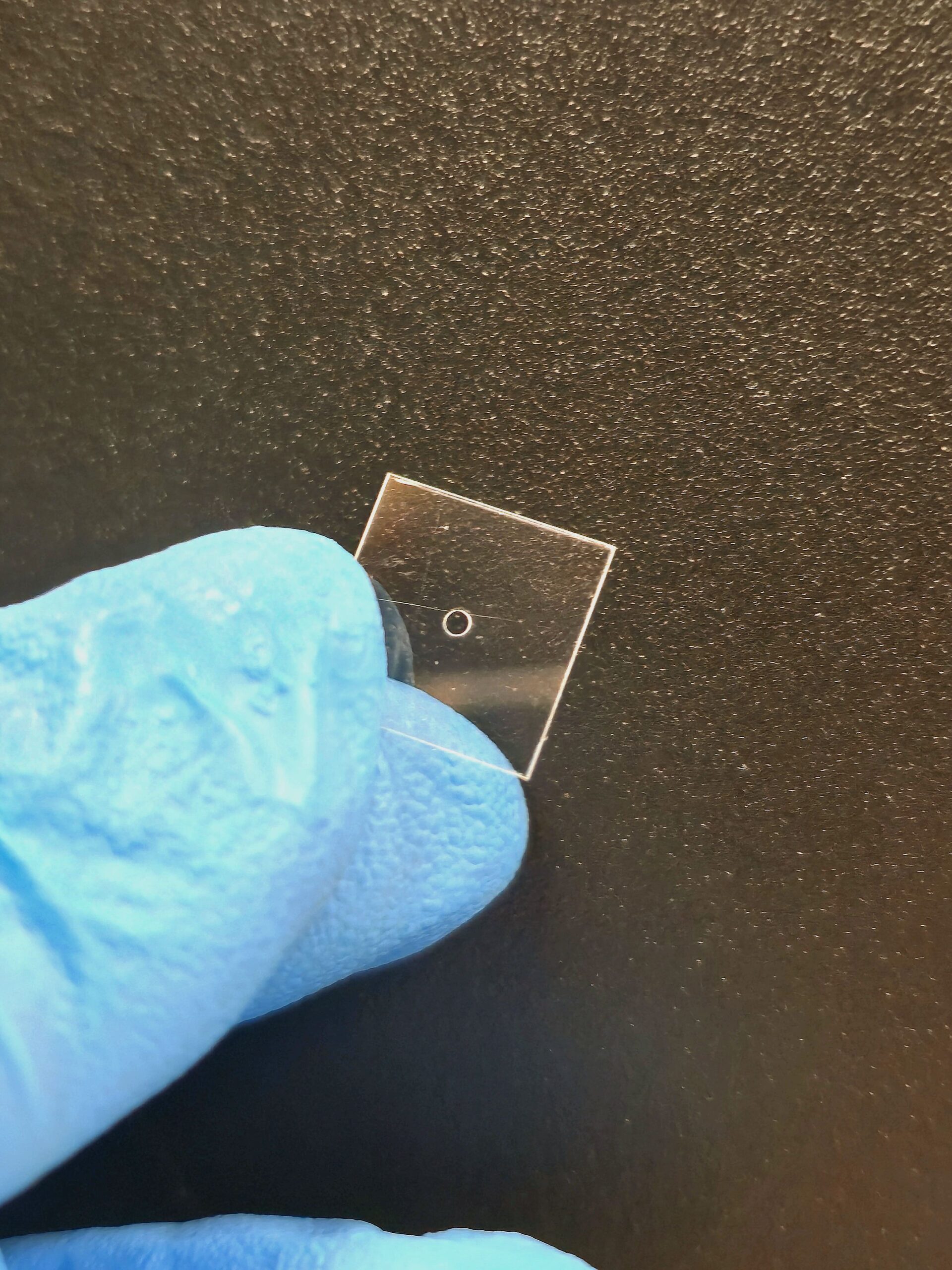 Laser-drilled hole in a thin fused silica plate